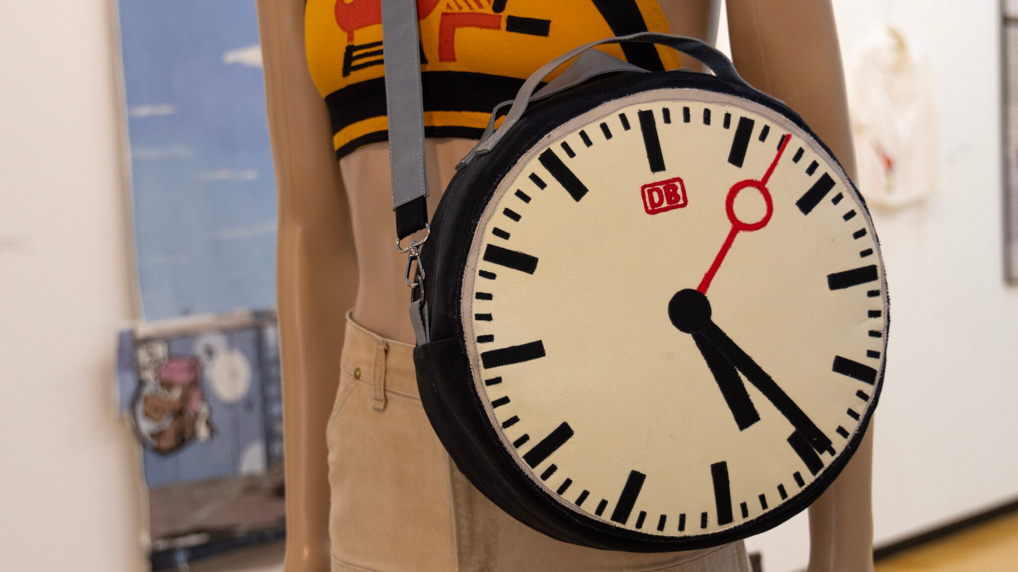 handsewn bag in the form of a clock on a mannequin