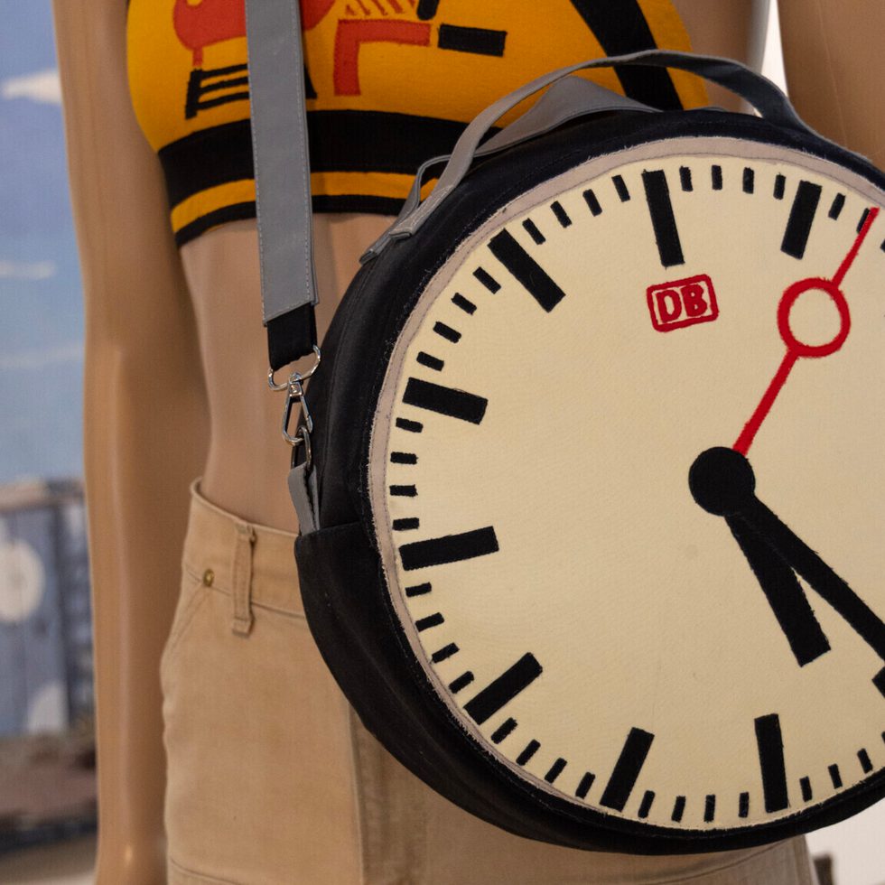 handsewn bag in the form of a clock on a mannequin