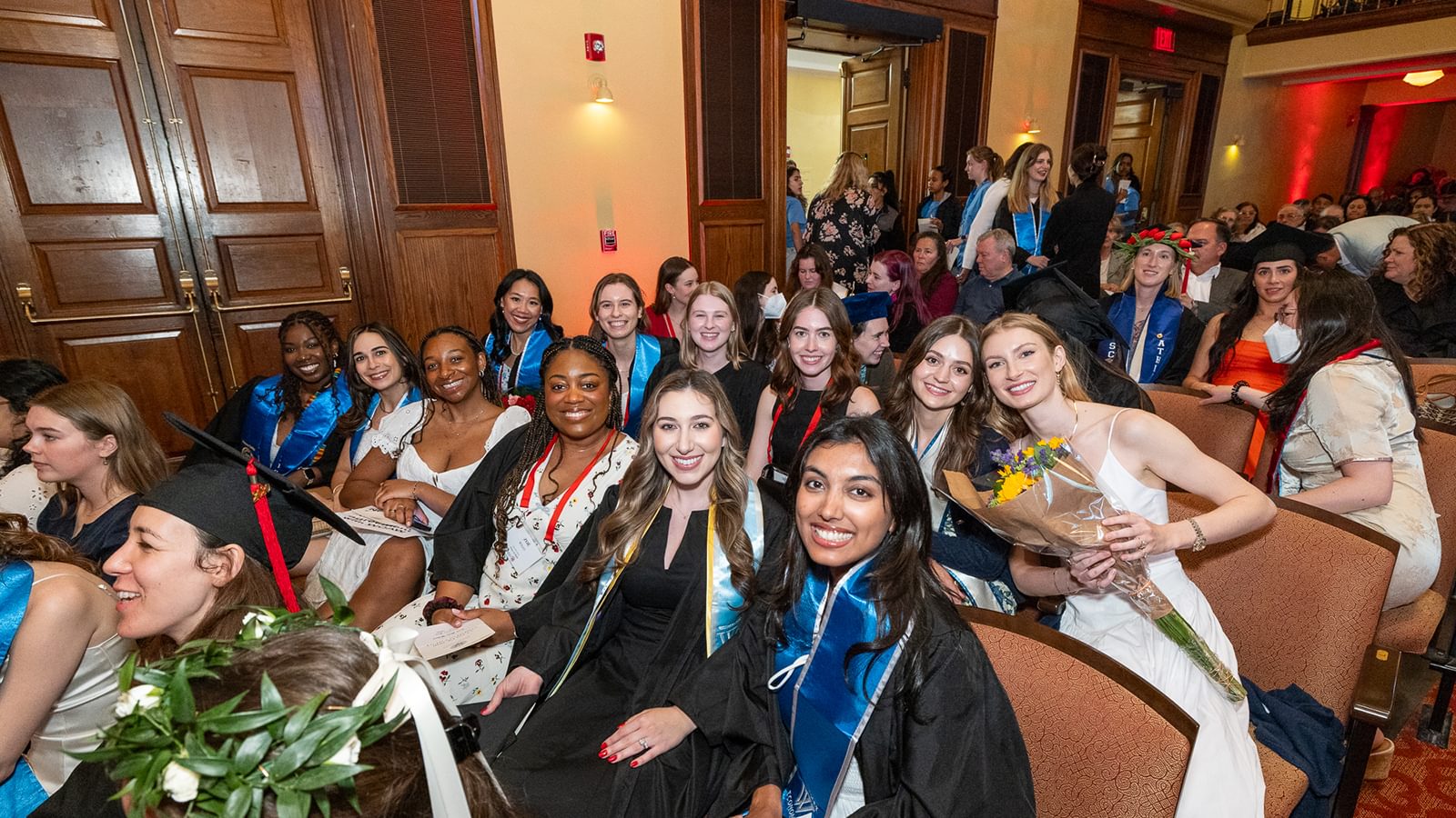 Class of 2020 are all smiles as they sit together in Alumnae Ballroom and smile for the camera.