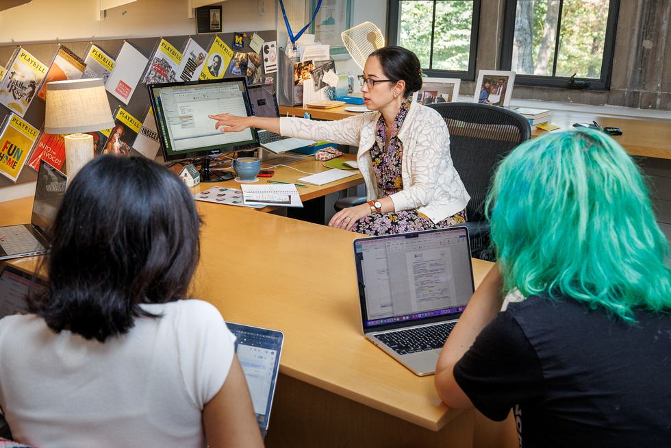 Professor Jennifer Chudy in her office with students, talking about data.