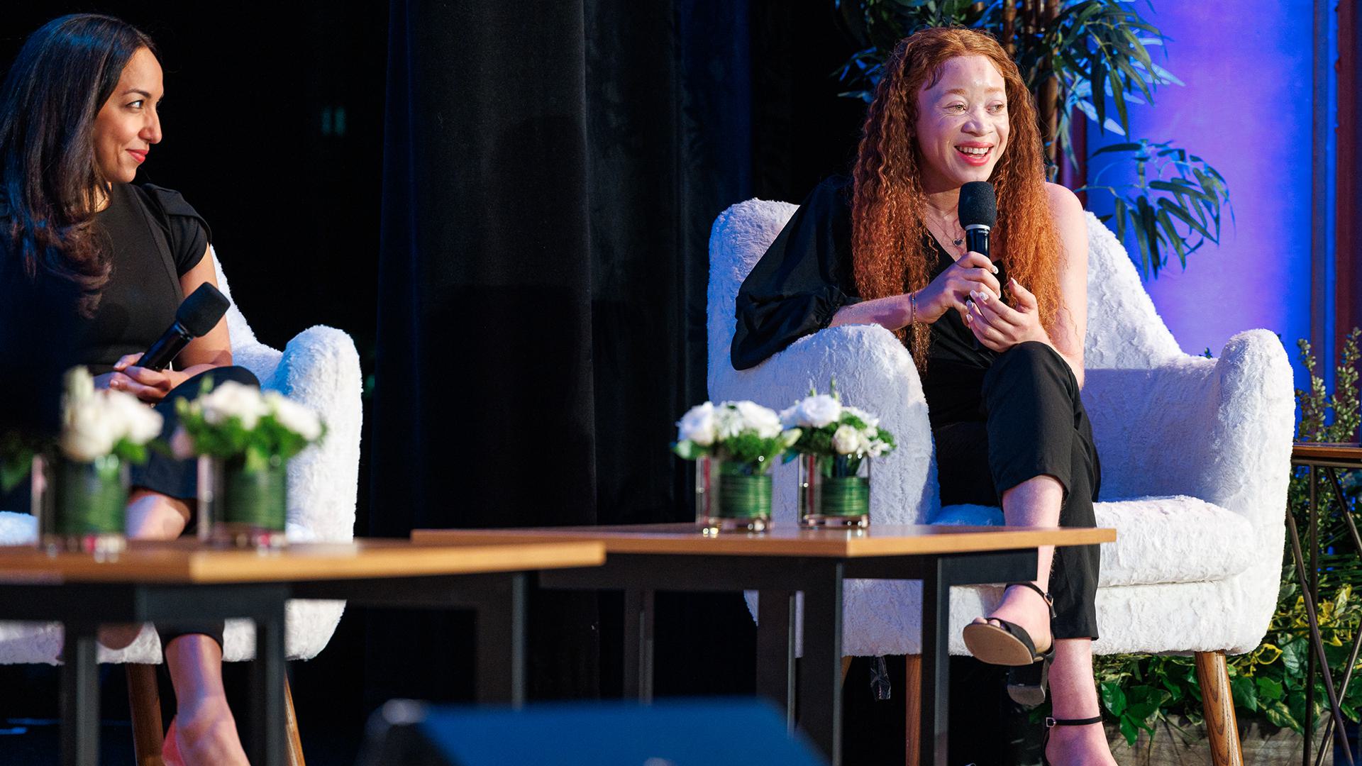 Chantale Zuzi ’25 smiles on stage while addressing the audience.