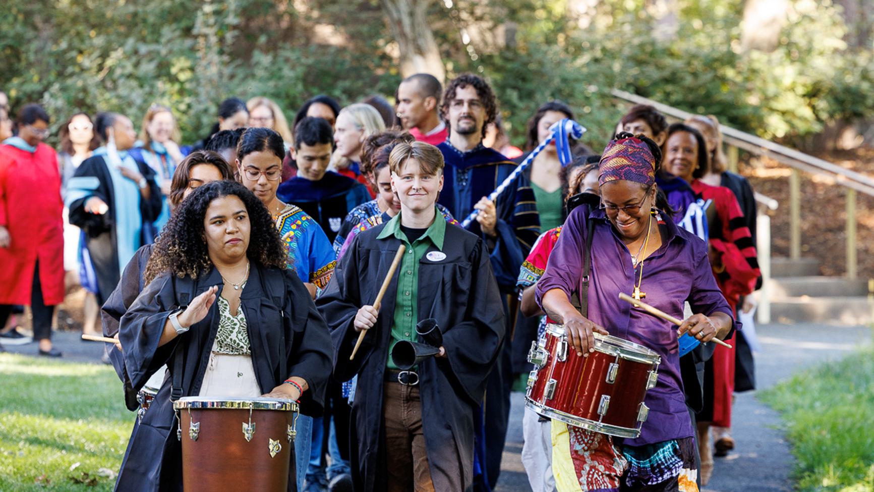 A group of drummers lead the convocation procession.