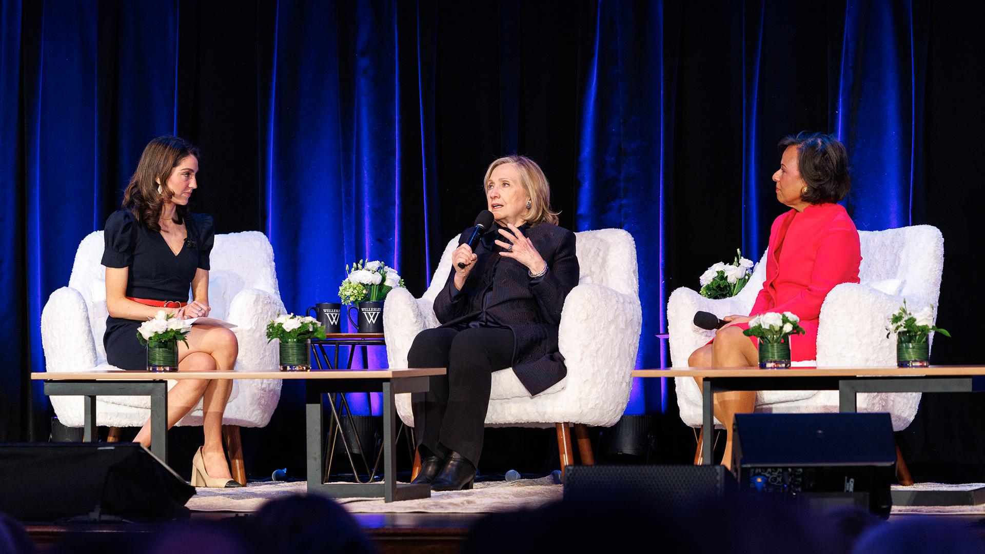 Arielle Mitropoulos ’19, Hillary Clinton and Paula Johnson speak on stage during the summit.