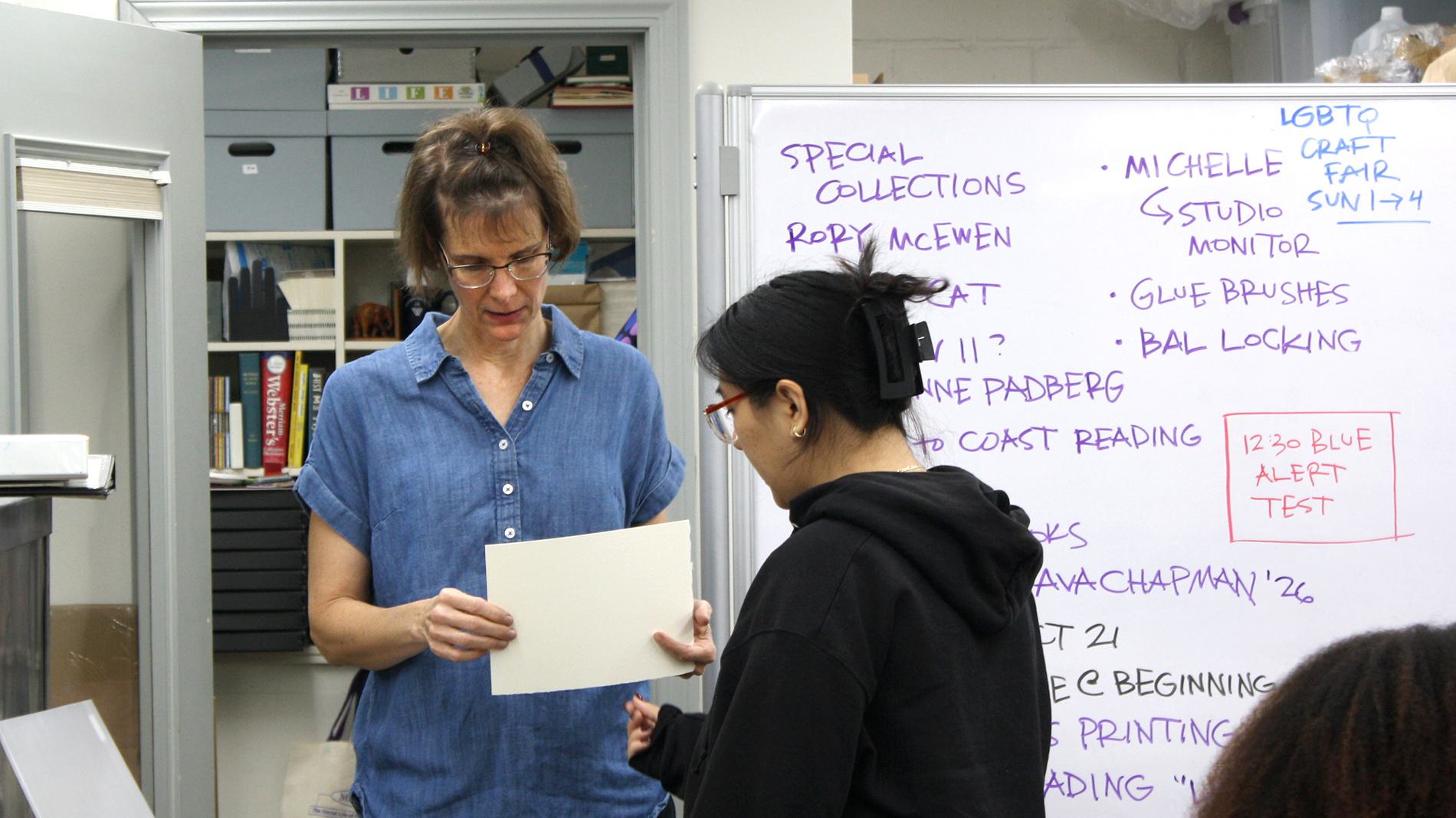 Katherine Ruffin, director of the Book Studies program and lecturer in art, speaks with Karla Narvaez ’26 during class in the book lab.