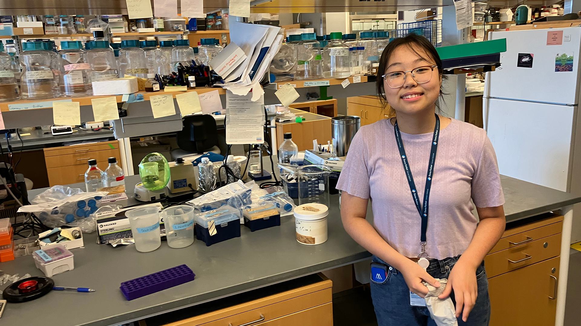 Misheel Amarsanaa ’25 posing in a lab, surrounded by equipment.