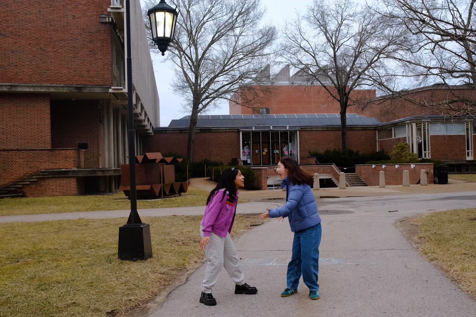 Two students look at each other in surprise.