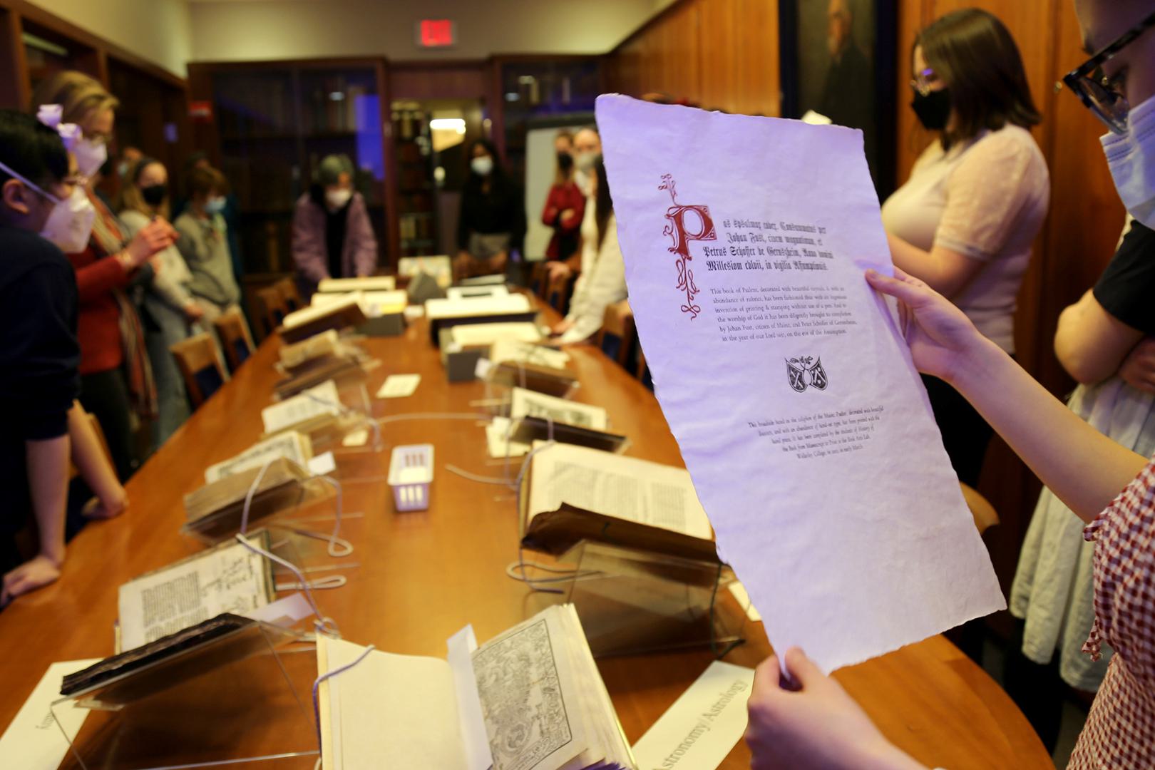 A student looks at a manuscript page