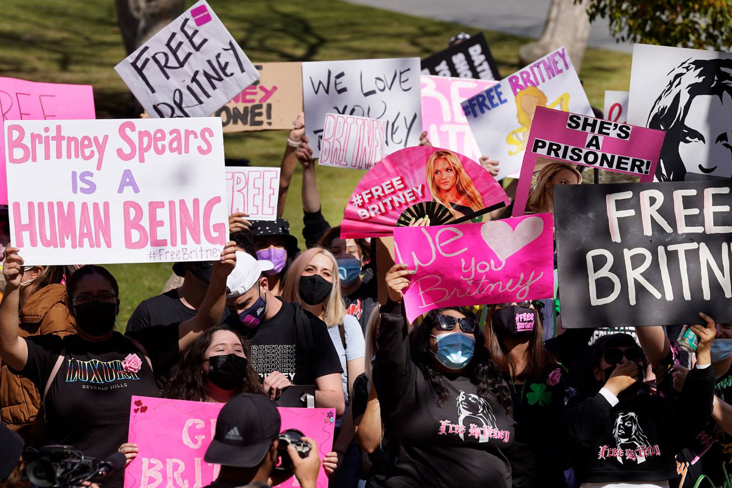 Britney Spears fans hold signs outside a Los Angeles court hearing concerning the pop singer’s conservatorship on March 17, 2021