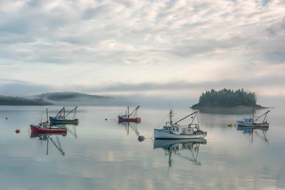 Fishing boats on the ocean at dawn