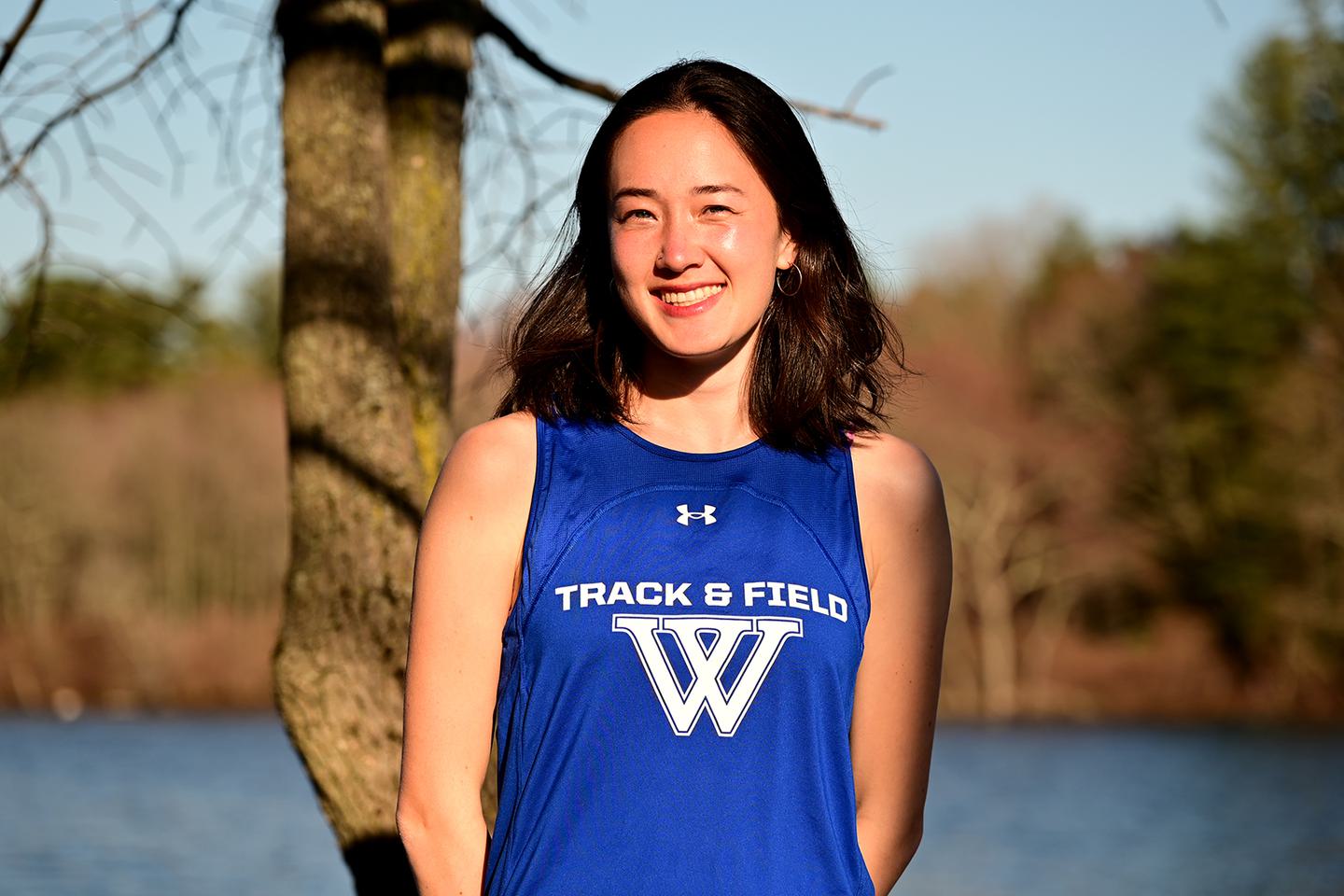 Ellie Murphy-Weise ’23 poses for a portrait in the late afternoon sun near Lake Waban.