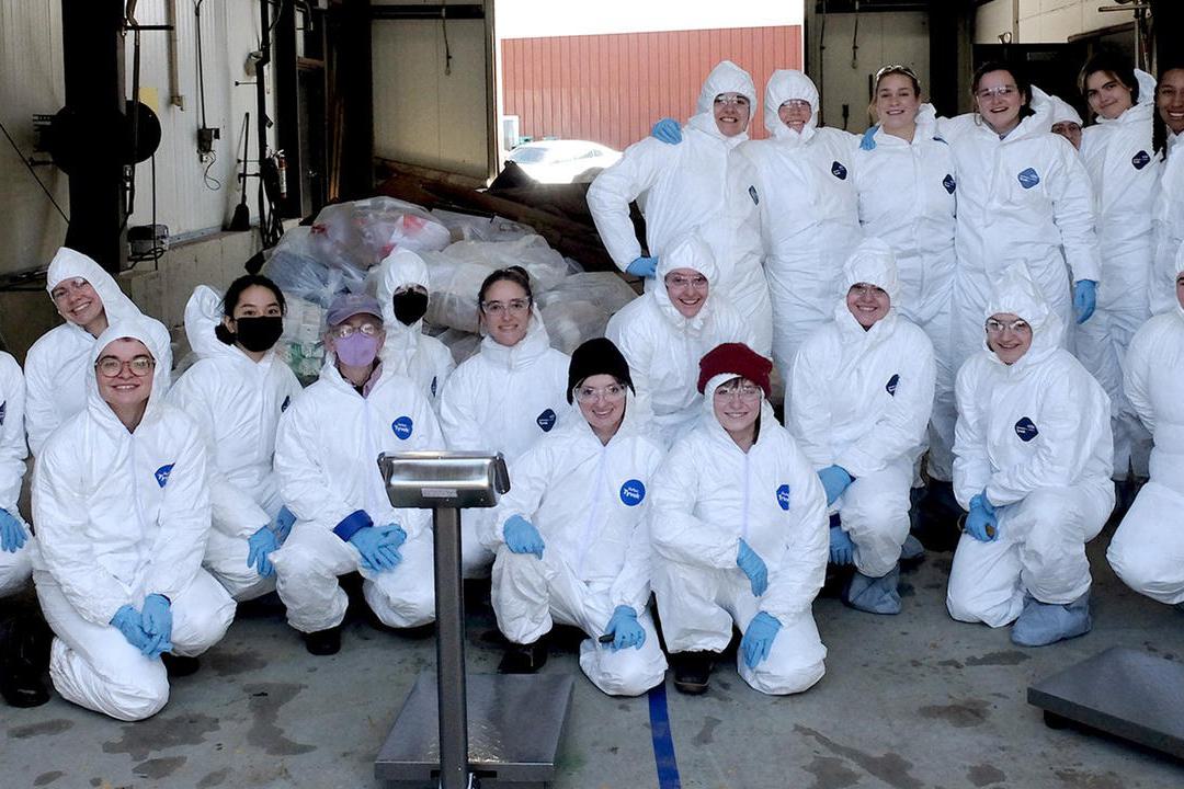 Students pose in their hazmat suits.