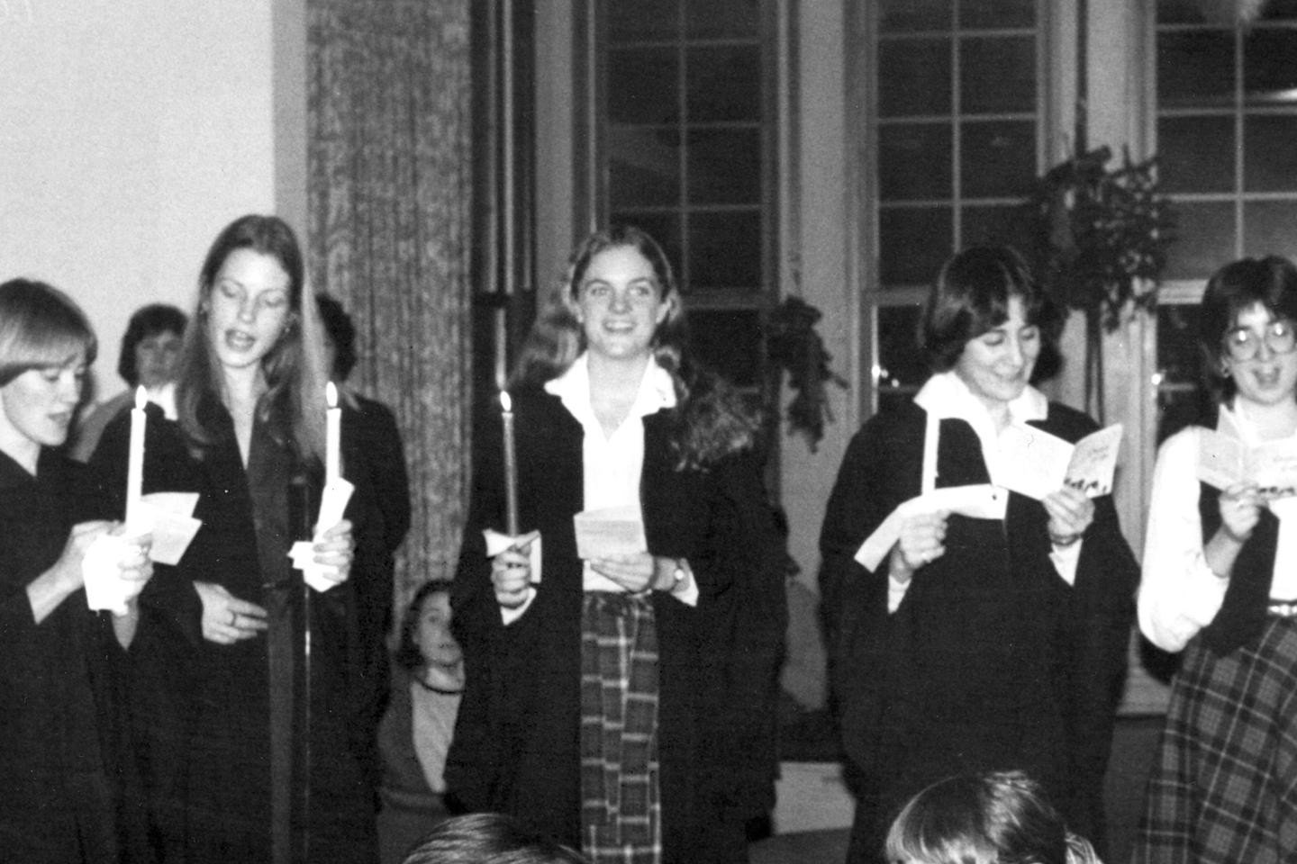 Vintage photo from 1980 showing students holding candles and singing for holidays.