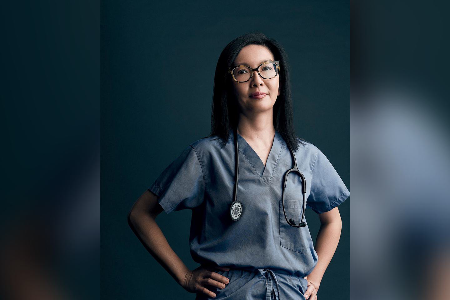 A portrait of Dr. Michelle Au ’99 in her scrubs and with a stethoscope around her neck.