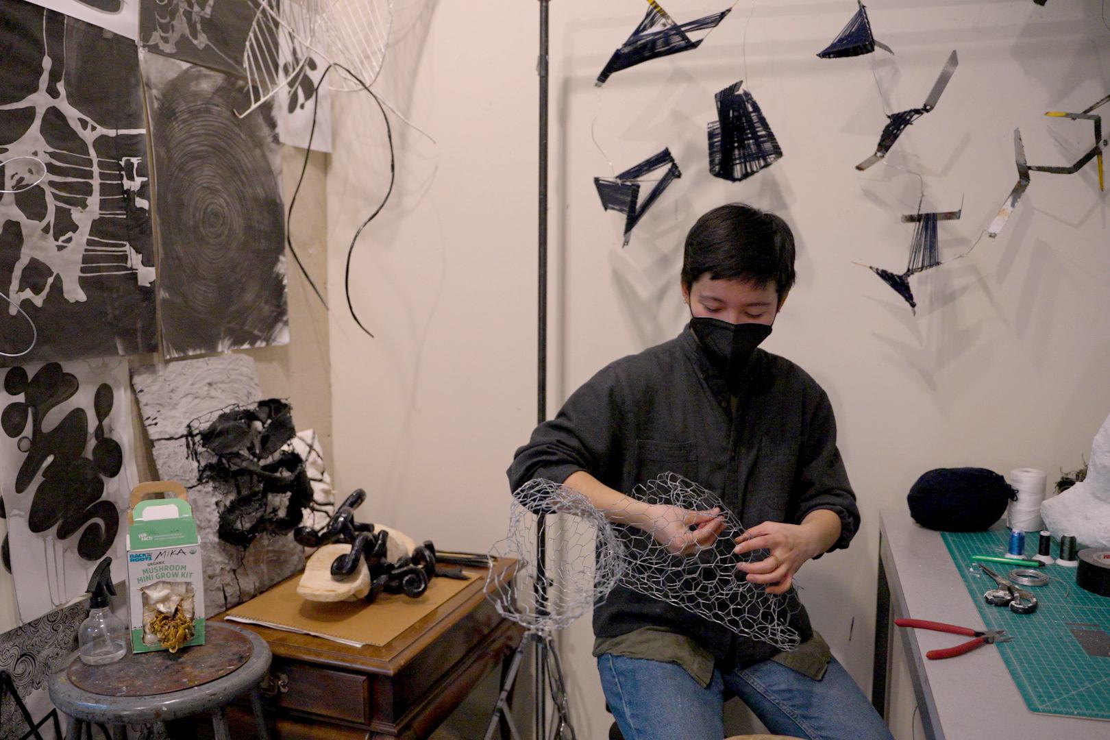 Mika Taga works in her art studio.