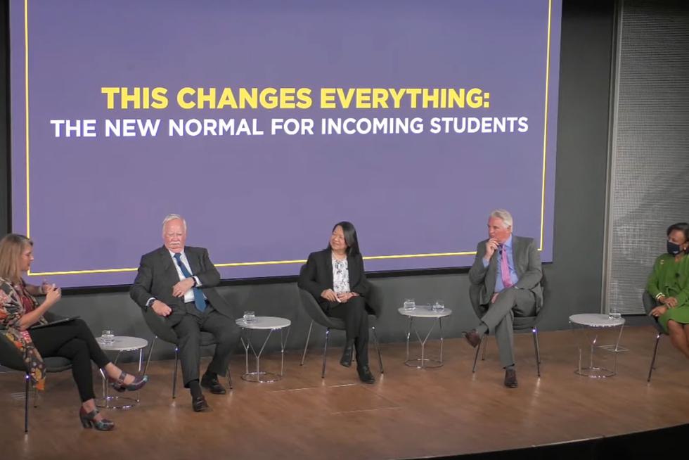 panelists sit on a stage