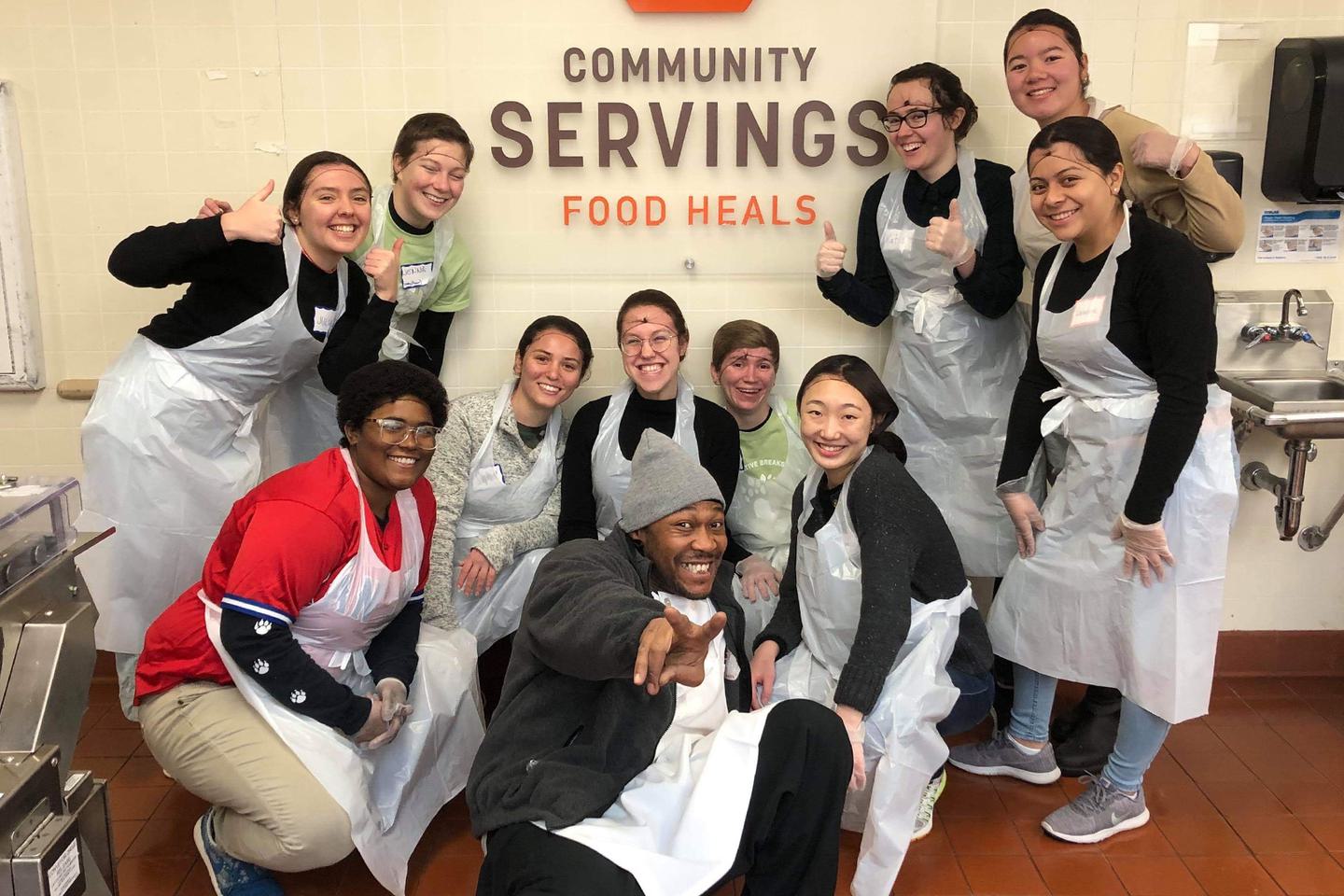 A group photo of students at Community Servings, a Boston nonprofit that cooks and delivers food.