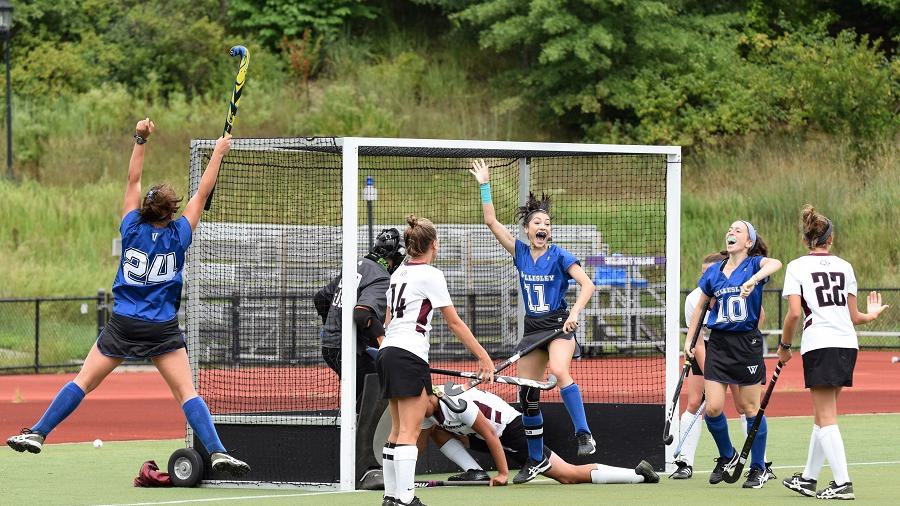 Wellesley College field hockey player, Arielle Mitropolis, celebrates with her teammates after scoring a goal.