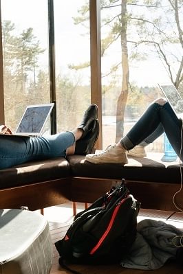 Two students sit with their laptops in the Lulu Chow Wang Campus Center