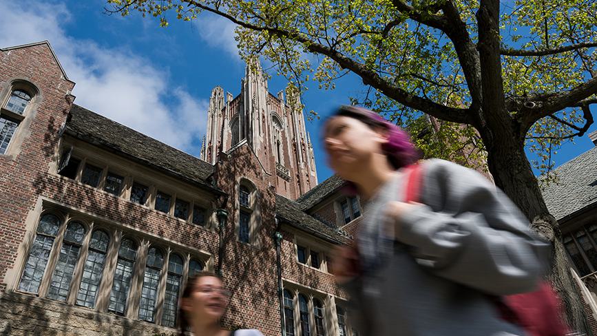Two college students walk through Wellesley College academic quad