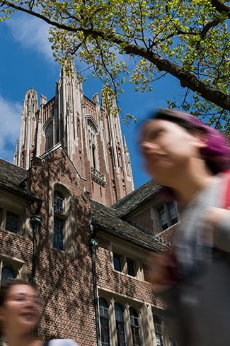 Two college students walk through Wellesley College academic quad