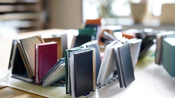 Books sit on a table in the Wellesley Clapp Library