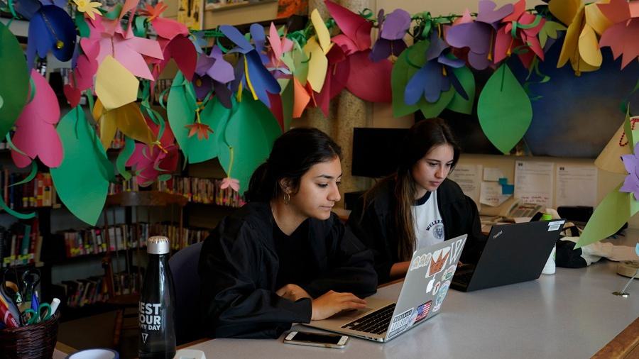 Two Wellesley College students work on their laptops in Jewett