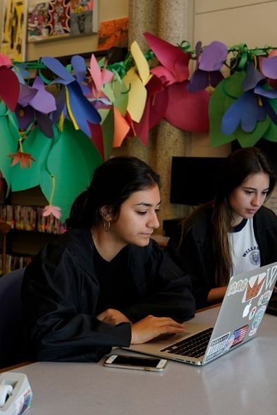 Two Wellesley College students work on their laptops in Jewett