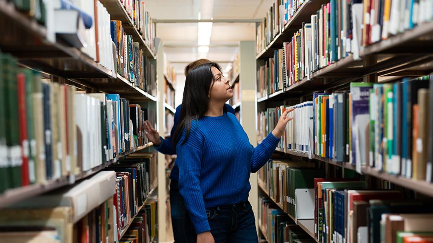 Two students browse for books in the Wellesley College Clapp Library