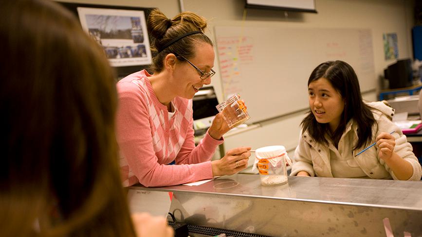 Wellesley College professor looks at sample in a lab science
