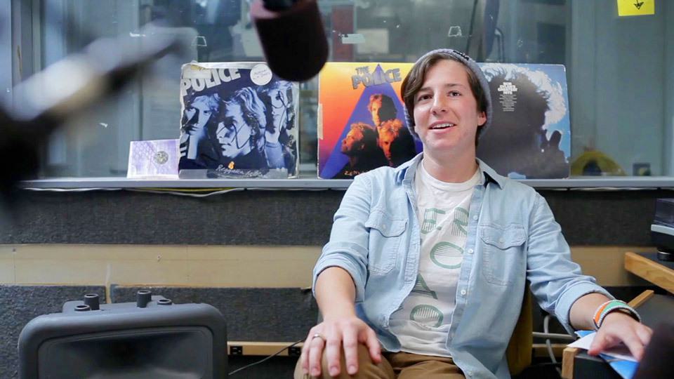A Wellesley College student DJ speaks into a microphone at WZLY, the country's first all-women college radio station,