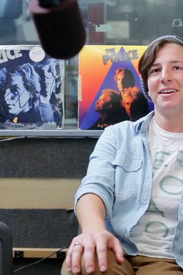 A Wellesley College student DJ speaks into a microphone at WZLY, the country's first all-women college radio station,