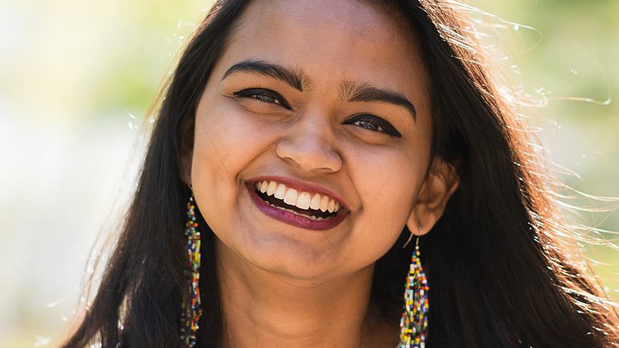 Kavi Thennakoon, Wellesley College alumna, poses for a photo while smiling