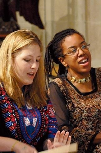 Two Wellesley College students play drums as part of Yanvalou Drum & Dance Ensemble, a group that performs the folkloric music and dance of Africa
