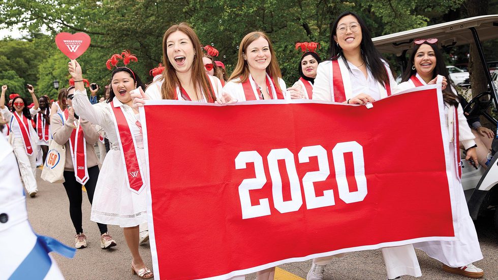 The class of 2020 behind their banner